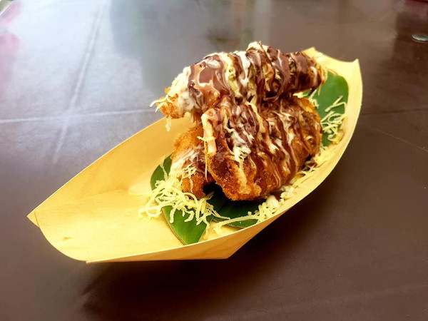 Pisang goreng presented on a boat-shaped container for a twist on nostalgic flavours