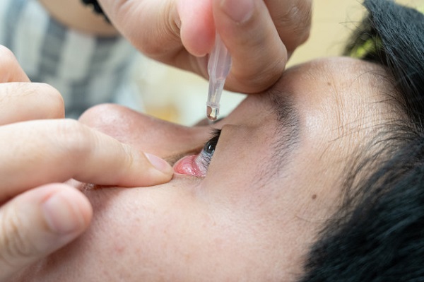 Using eye drop to moisturise your eyes and relieve eye-sore. 
