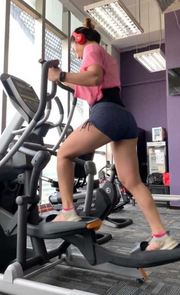 Vicky Lee training on elliptical trainer or cross-trainer (also called an X-trainer) machine for her bodybuilding competitions