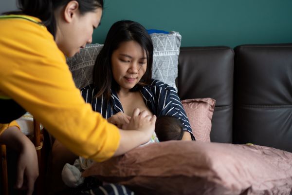 a mother gets support from a person; whether family or staff, to help with breastfeeding.
