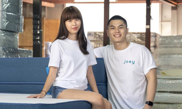 Joey Tan (left) and Winson Choong posing on with their J-foam mattress.