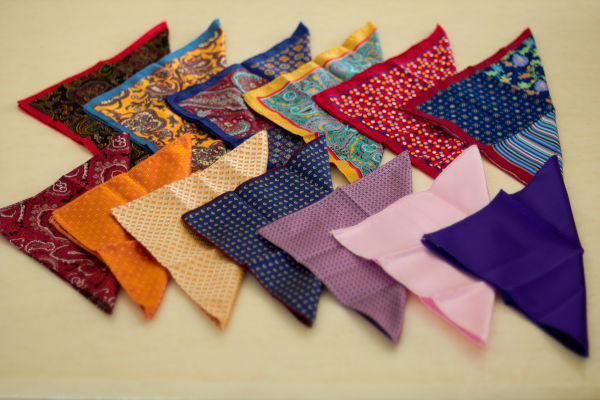 A plan view of a variety of pocket squares on a table.