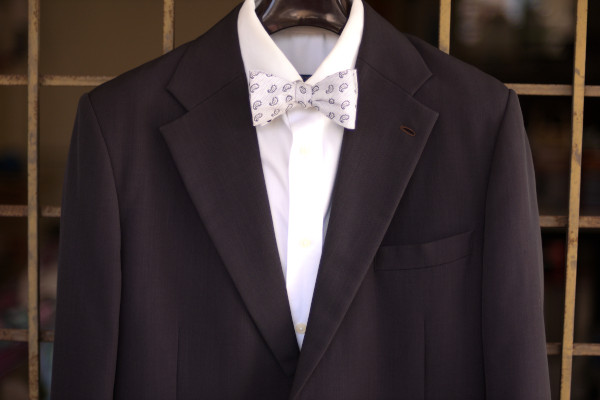 Close-up of an ensemble as described in the caption, matched with a solid white shirt and charcoal grey suit jacket.