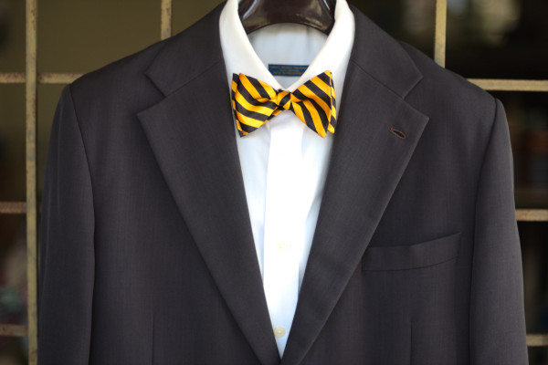 Close-up of an ensemble as described in the caption, matched with a solid white shirt and charcoal grey suit jacket.