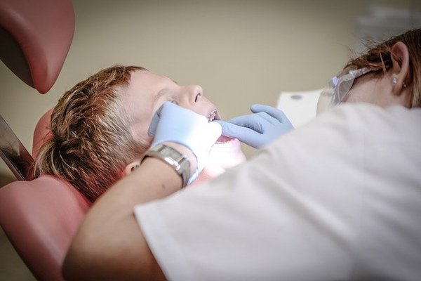 root canal - A dentist performs a dental procedure on a child.