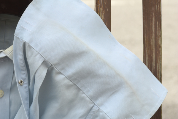 Close-up  of the sleeve cuff of the light blue shirt, showing the yellowing along the crease of the unfolded double cuff.