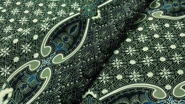 A Kediri style batik in green with detailed patterns with different shapes.