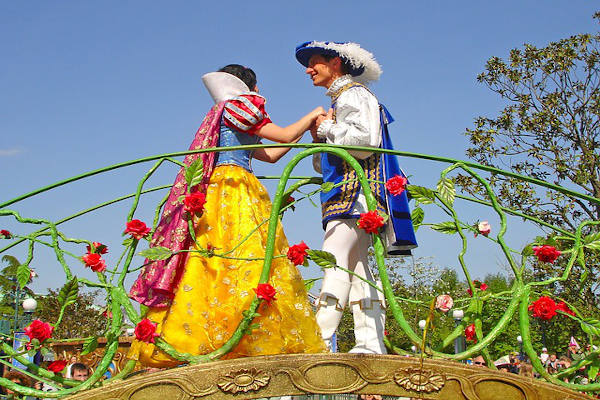A prince & princess holding hands on a bridge. The classic fairytale ending for monogamy. 