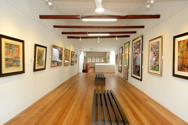 The interior of the batik museum with frames of paintings on the wall.