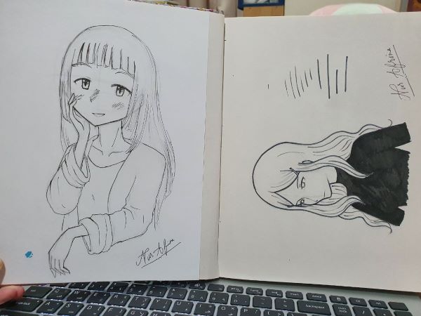 Drawing of anime girl on sketchbook. 