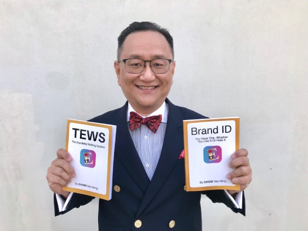 The Author holding up both TEWS and Brand ID, proudly showing them off.