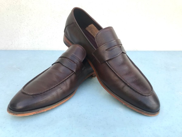 A pair of brown penny loafers.