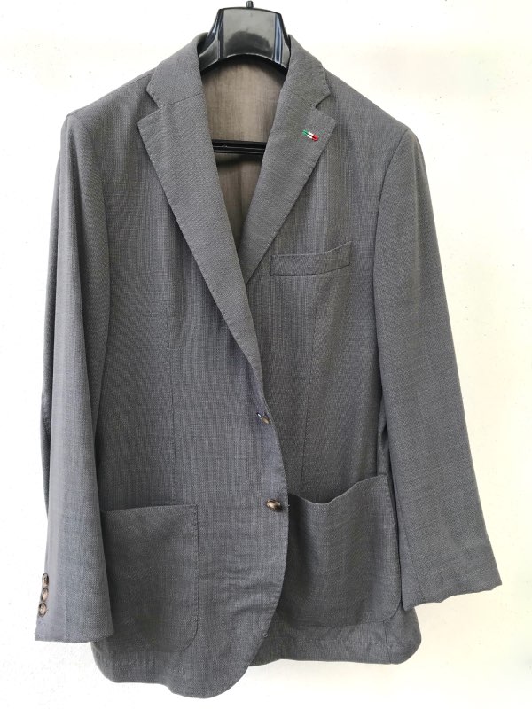 Medium grey, two-button, single breasted sport jacket, in hopsack coarse weave. This is the sartorial advance level jacket.