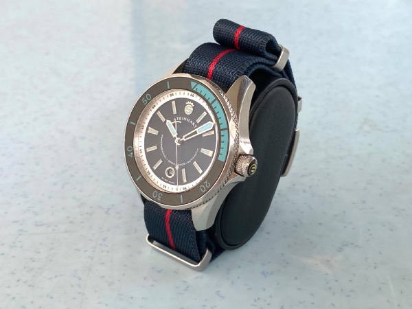 Profile view of the Steinhart Ocean 2 diver with a nylon NATO strap in place of its stock bracelet. The added bulk is visually evident here.