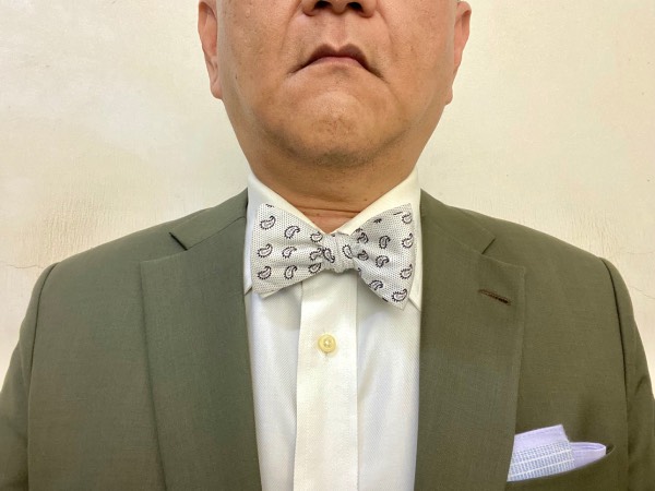 Close-up of the chest displaying a typical business formal outfit, emphasising the bow tie instead of a regular long tie.