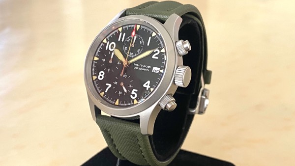 Close-up of the Militado ML1868 field watch with an olive green sailcloth strap.