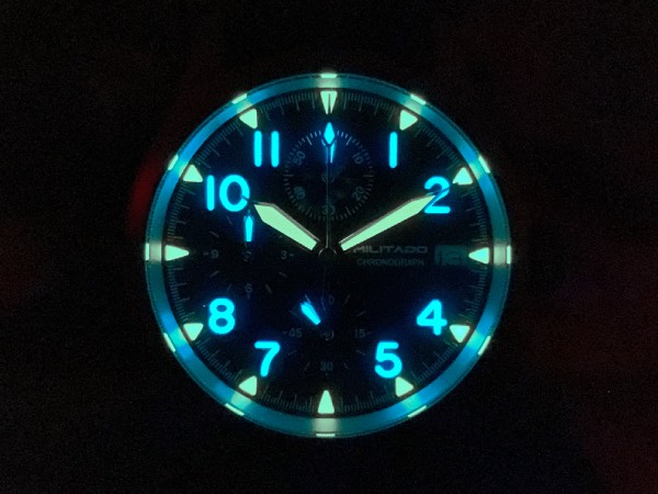 Close-up of the ML1868 field watch, dial face in total darkness, showcasing the dual-coloured lume.