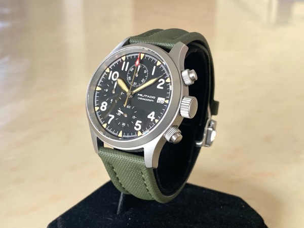 Close-up of the Militado ML1868 field watch with an olive green sailcloth strap.
