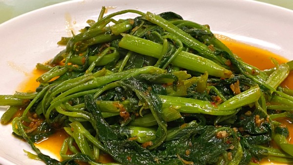 Close-up of a plate of stir-fried kangkung belacan.