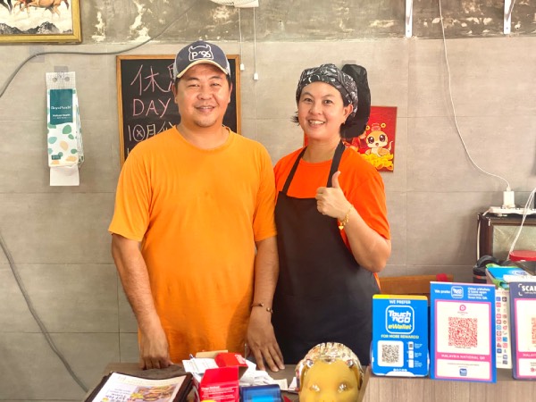 Siblings, Wilfred (left) and CC Chong (right) are the co-owners of Zhang Kee. Here they're standing behind the restaurant's counter.