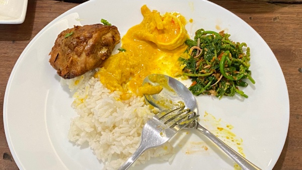 Close-up view of a plate of a single serving. It contains white rice, Inche Kabin (fried chicken), Pineapple Prawn Curry, and Kerabu Asam Paku.