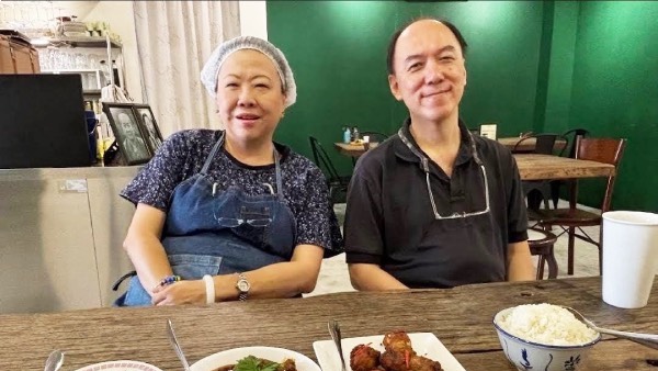 Carol Kuok and Ng Teik Piew, seated side by side, at one of the tables in Sri Nyonya Bistro.